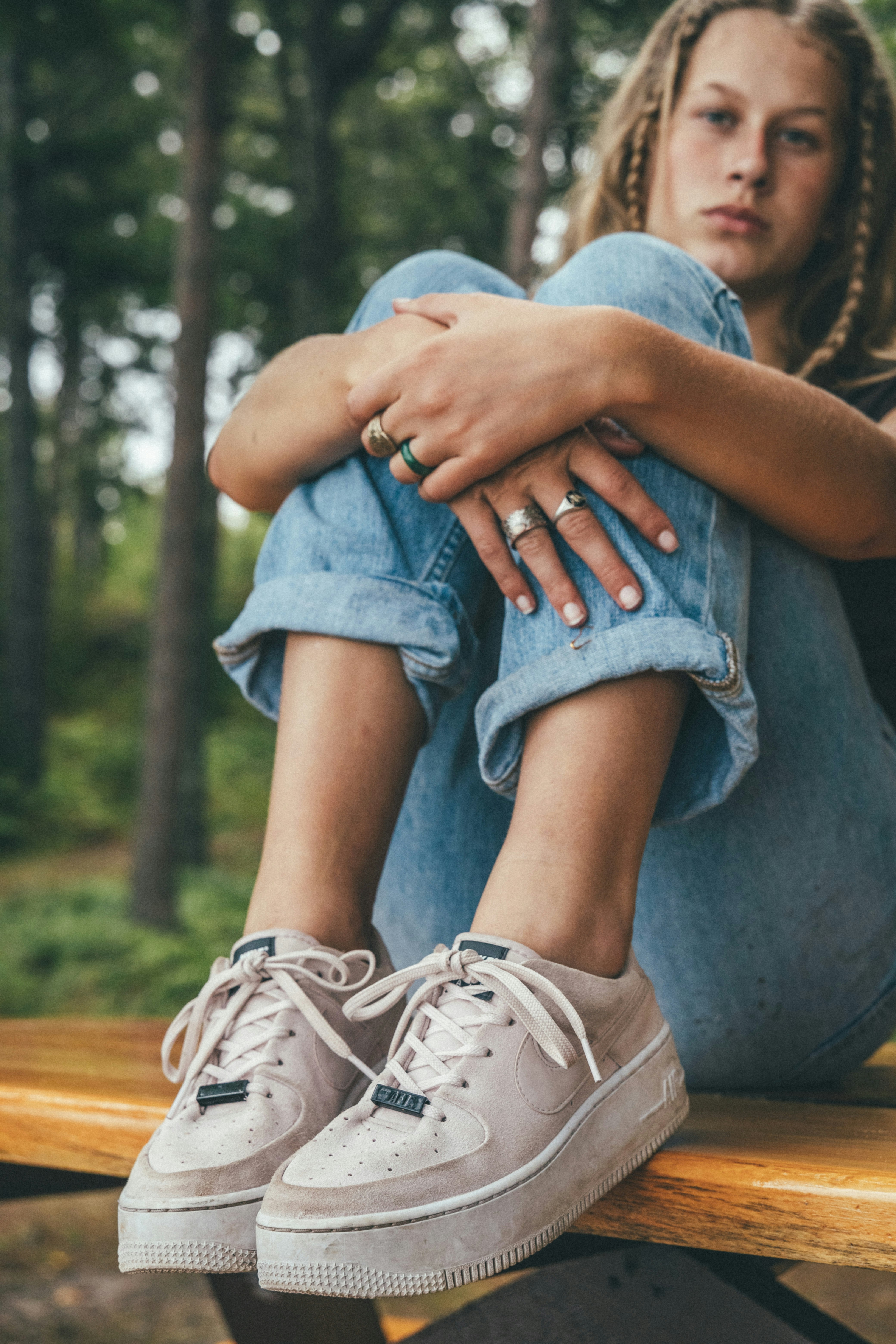 person wearing blue denim jeans and brown hiking shoes